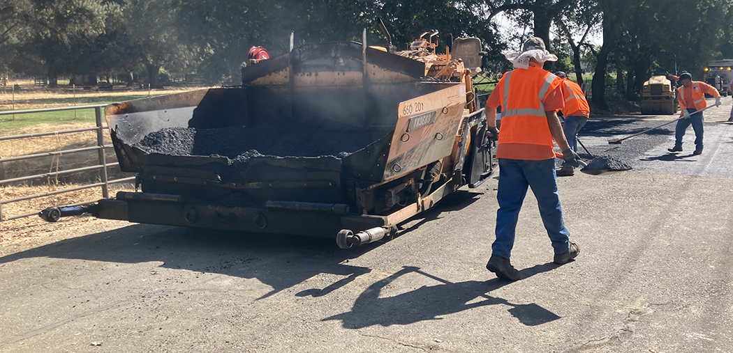 Crews paving road